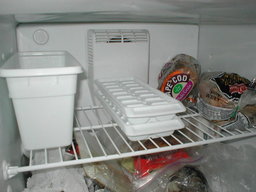 two trays stacked on upper shelf