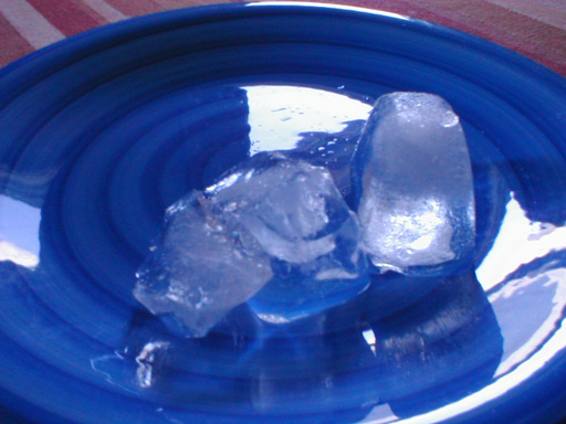 two cubes on a blue plate, one broken