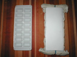 making cubes with a towel wrapped around the tray