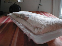 two trays stacked, top tray with towel-lid